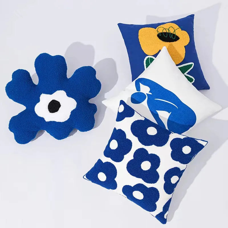 Bright blue flowers embroidered on a white 45x45cm pillow