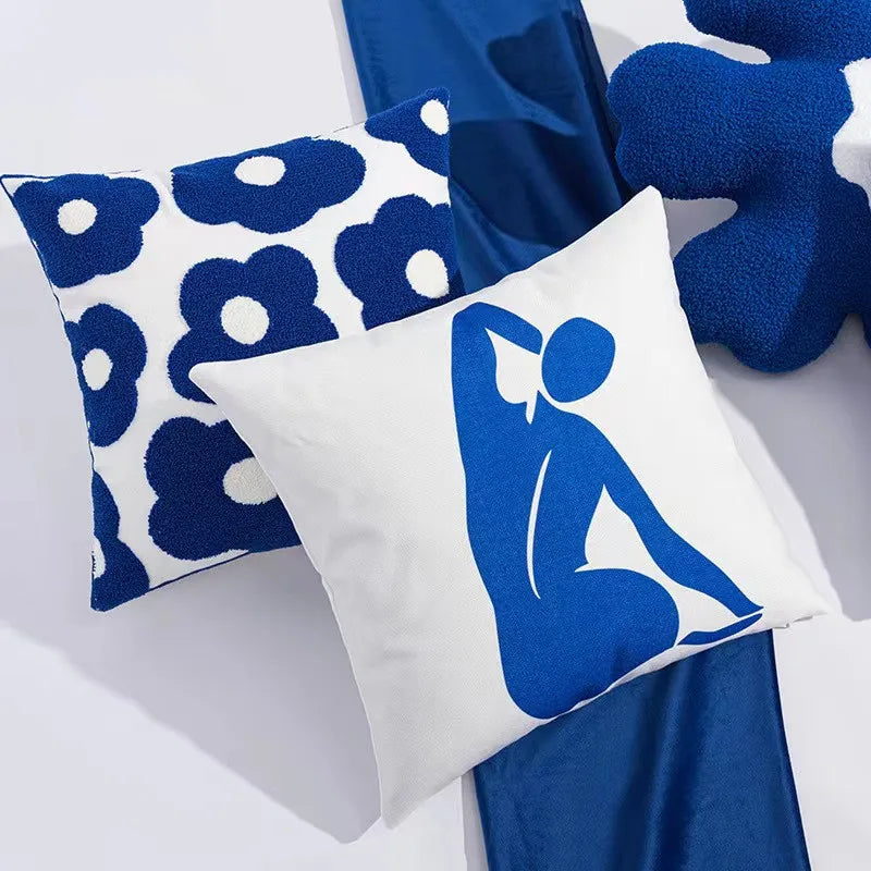 Bright blue flowers embroidered on a white 45x45cm pillow, creating a vibrant and elegant floral design-c05a-43ca-85f6-77669d2f4c73