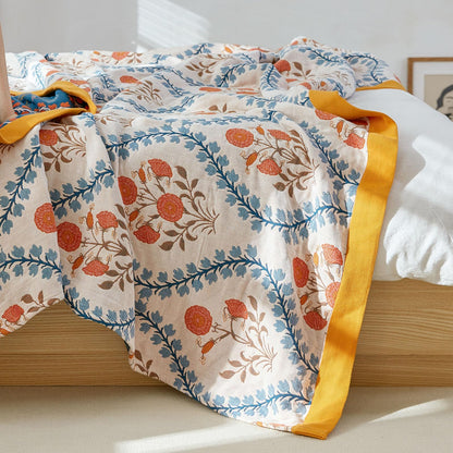 Close-up of peaceful floral design featuring ivory petals, golden leaves, and indigo stems on olive cotton fabric