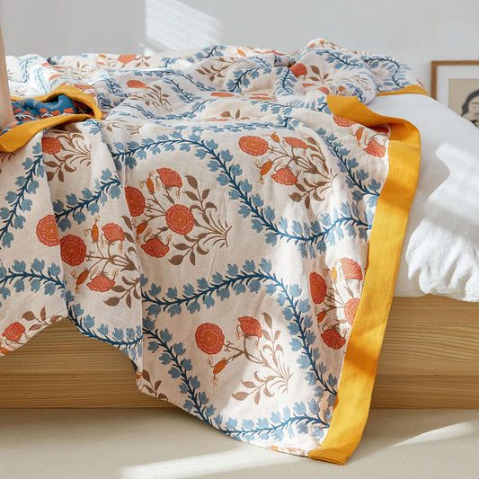 Close-up of peaceful floral design featuring ivory petals, golden leaves, and indigo stems on olive cotton fabric
