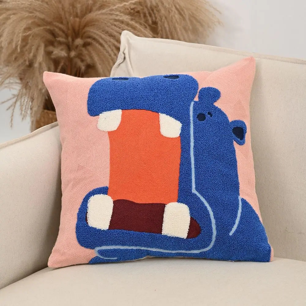 Embroidered hippo pillow in bright blue on a pink background; square cushion with hidden zip, 45x45cm, playful yet grounding home accent