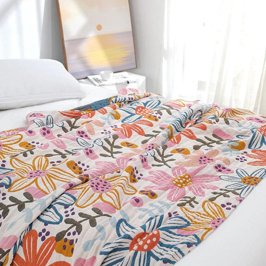 Five layers of cotton gauze catching natural light, revealing woven floral lines and breathable texture
