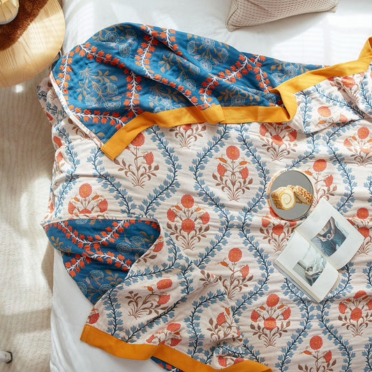 Garden of Stillness Throw in deep olive green with hand-drawn ivory, gold, and indigo floral motifs, laid out flat