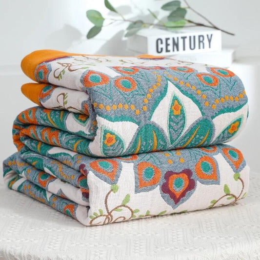 Mandala Radiance Throw featuring centred lotus mandala designs in teal, saffron, and aubergine with ochre border,