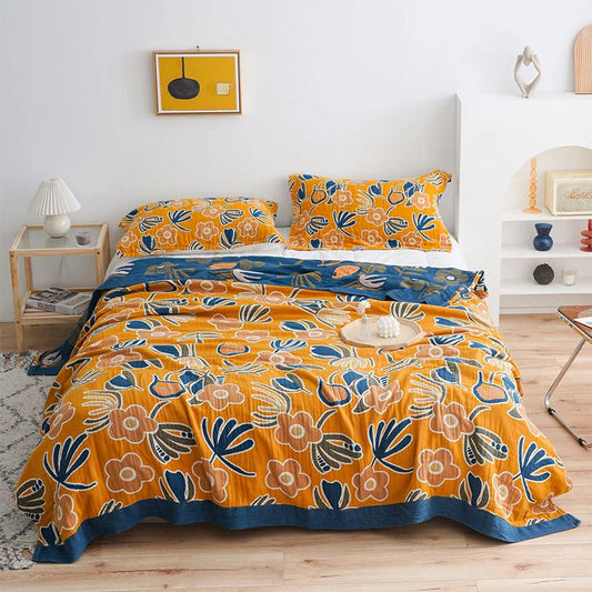 Olive green cotton throw with ivory, gold, and indigo floral design, inspired by a quiet meadow and mindful living