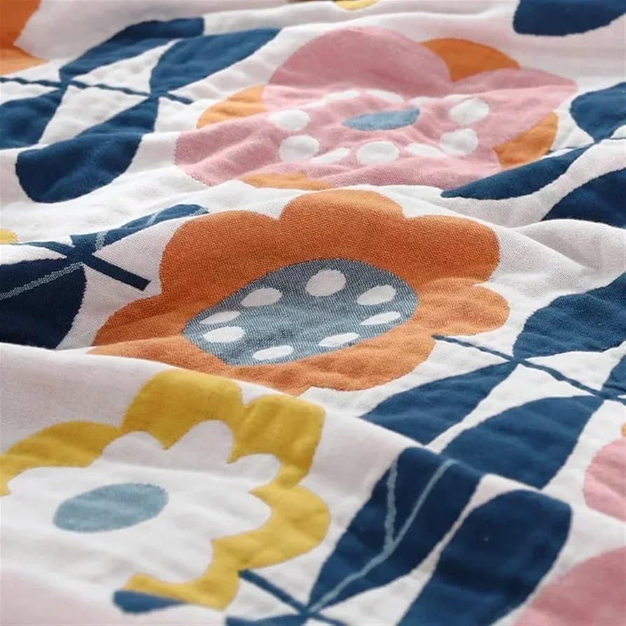 Retro-inspired floral throw blanket with sacred geometry design in warm earthy tones, styled on a neutral bed